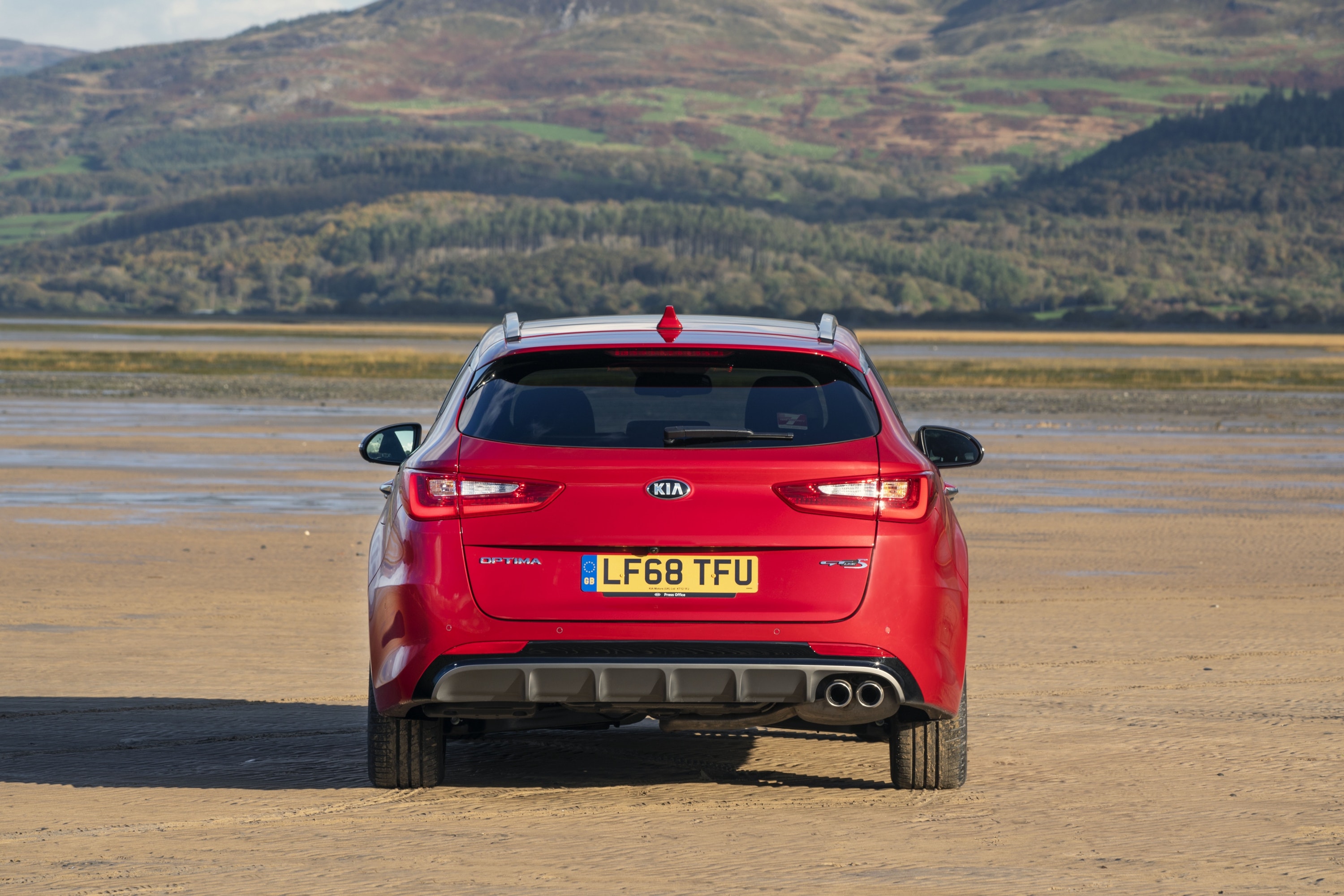 Back of a red Kia Optima Sportswagon